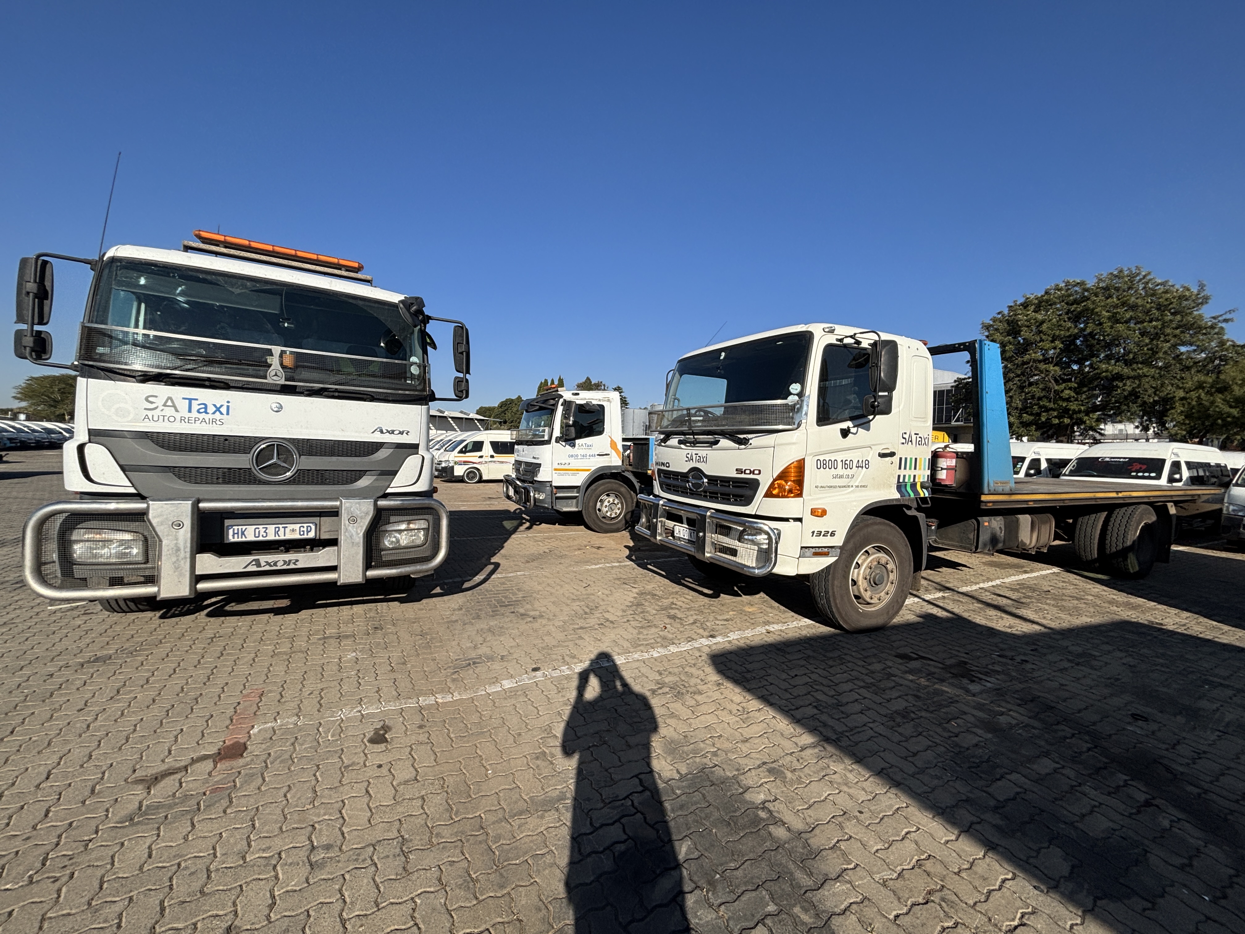 Lineup of SA Taxi vehicle transporters during fleet detailing in Midrand